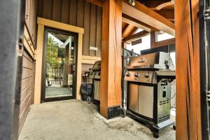 an outdoor kitchen with a stove on the side of a building at Timberline Lodge by StayIn in Fernie