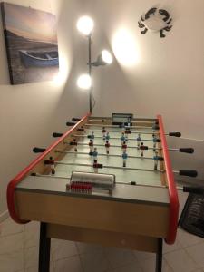 a large billiard table with avertisement for at Maison rénovée à 300m de la mer in Saint-Hilaire-de-Riez