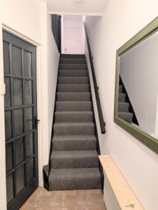 a staircase leading up to a door in a building at Ivy Townhouse Derry in Derry Londonderry