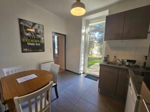 a kitchen and dining room with a table and a sink at proche centre calme jardin privé in Nantes
