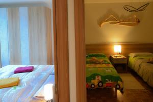 a room with a bedroom with a bed and a window at Appartamento BUCANEVE in Pieve Tesino