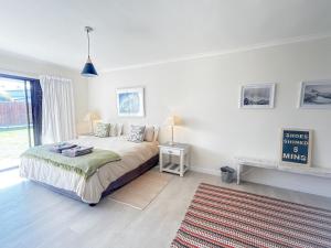 a white bedroom with a bed and a rug at Langebaan-On-Sea in Langebaan +21 photos