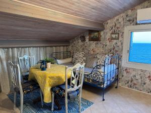 a room with a table and chairs and a room with the ocean at Villa Elisabeth Saint-Raphaël in Saint-Raphaël