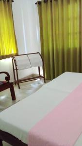 Postel nebo postele na pokoji v ubytování New Manik Homestay