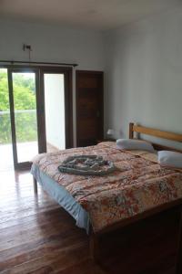 ein Schlafzimmer mit einem Bett mit einer Decke darauf in der Unterkunft sunshine home in Paraty