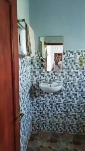 a person taking a picture of a bathroom with a sink at Penginapan & Homestay Ratu Pantai Geopark Ciletuh in Cikadal +19 photos
