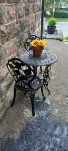 a table with a bowl of flowers on it at Woodfield hideaway in Matlock