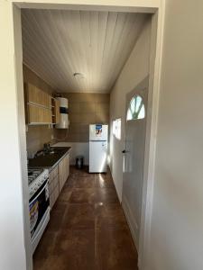 a kitchen with a white refrigerator and a sink at Paz&Mar in Mar del Sur +17 photos