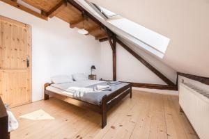 a bedroom with a bed and a skylight at Charming Rustic Old Town Apartment in Krakow