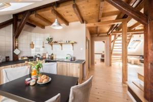 a kitchen and dining room with a black table and chairs at Charming Rustic Old Town Apartment in Krakow
