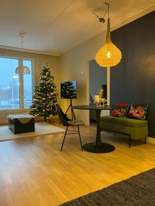 a living room with a table and a christmas tree at Bohemian Luxury with private Sauna, own carparking, 3 km from airport in Vantaa