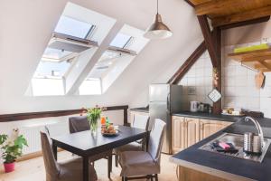 a kitchen with a table and a kitchen with skylights at Charming Rustic Old Town Apartment in Krakow +6 photos