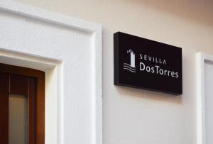 a sign on a wall next to a door at Sevilla DosTorres in Seville
