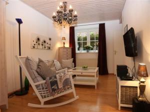 a living room with a couch and a tv at Romantikappartements Staufen in Staufen im Breisgau