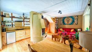 a kitchen and living room with a couch and a table at Zielona Perspektywa Agroturystyka in Huta Różaniecka