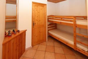 a room with two bunk beds and a closet at Le Chalet des Séraphins in Saint-Sorlin-dʼArves +8 photos
