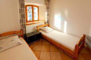 a bedroom with two beds and a window at Le Chalet des Séraphins in Saint-Sorlin-dʼArves