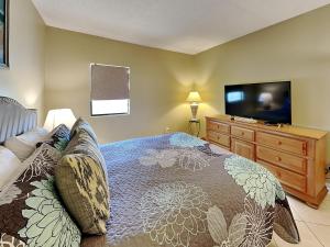 a bedroom with a bed and a flat screen tv at Sunkissed Escape in Jacksonville Beach