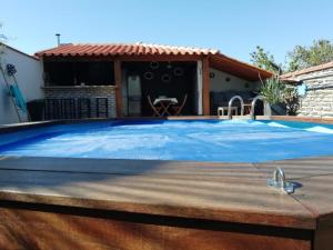 a swimming pool in a backyard with a house at Chambres dans maison atypique in Ille-sur-Têt