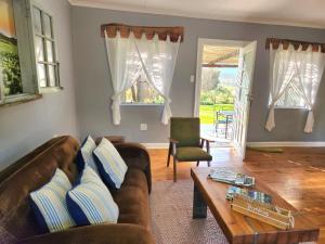 a living room with a couch and a coffee table at Môreson Cottage in Klaarstroom