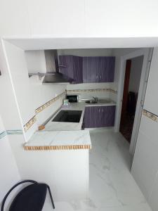 a small kitchen with a sink and a stove at Jaén Ways in Jaén