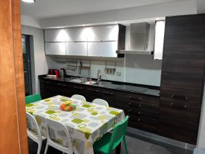 a kitchen with a table and chairs and a kitchen with a table at Luxury Apartment near Beach & Golf in Amora