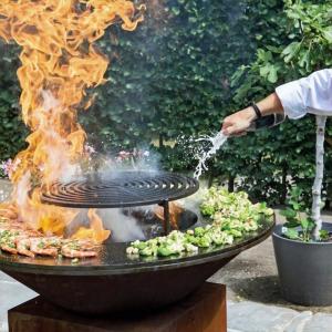 a person is cooking food on a grill with fire at João Jungle in Açafora