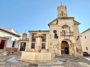 a building with a fountain in front of a building at Villa Tortola II in Antequera