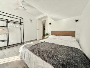 a bedroom with a large bed and a window at Villa Tortola II in Antequera