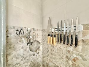 a row of knives hanging on a wall at Villa Tortola II in Antequera +29 photos