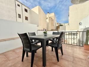 a black table and chairs on a balcony at Villa Tortola II in Antequera