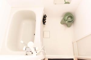 a bathroom with a sink and a toilet on the wall at BREEZE furano 205 in Furano +40 photos