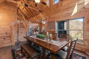 a dining room with a wooden table and chairs at Woodlake Log Cabin in Elk Park