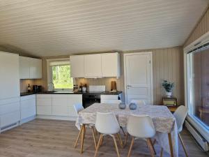 a kitchen with a table and chairs in a room at Cabin with lovely view in Lakså