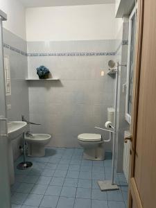 a bathroom with a toilet and a sink at Albenga La Romantica in Albenga
