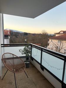 a balcony with a chair and a view at Proche Genève - Cosy Appartement in Reignier