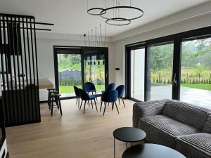 a living room with a couch and a table and chairs at Wisełkowe Zacisze in Wisełka