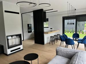 a living room with a couch and a tv and chairs at Wisełkowe Zacisze in Wisełka +25 photos