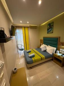 a bedroom with a bed with yellow and blue at StelSif Studio's in Atsipopoulo