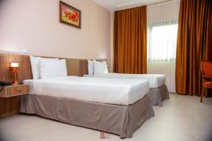 Voodi või voodid majutusasutuse Hôtel KEMAKA toas