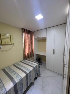 a small bedroom with a bed and a window at Aconchego em Campo Grande - Guaratiba in Rio de Janeiro +9 photos