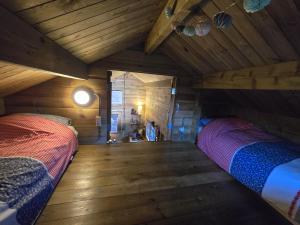 a bedroom with two beds in a attic at Tiny House Bad Nieuweschans in Bad-Nieuweschans