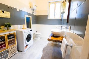 a bathroom with a washing machine and a sink at Boutique Trastevere Rome apartment Ripa 12 in Rome
