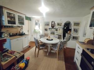 a kitchen with a table and chairs in a room at Honey house Lika in Gospić
