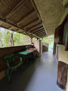 a room with a table and chairs and a refrigerator at Suítes Cachadaço Beach in Paraty +19 photos