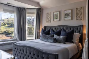 a bedroom with a large bed with a large window at Victorian House-30 mins to Napa & SF, Free Pets! in Crockett