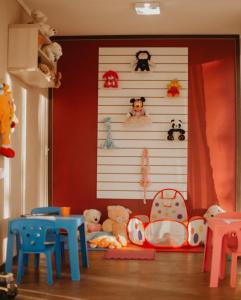 a childs room with toys on a wall at Hotel Colina São Francisco in Gramado
