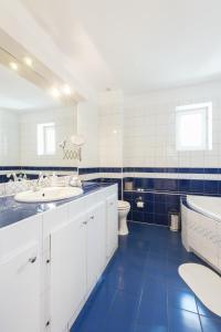 a bathroom with two sinks and a tub and a toilet at Charming Rustic Old Town Apartment in Krakow