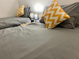 a bed with two pillows on top of it at Central Halifax Work & Retreat Base - Two bedroom house - sleeps up to 4 - free parking and internet in Halifax +10 photos