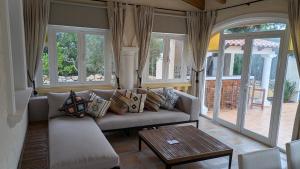 a living room with a couch and a table at Villa Carolina in Jávea